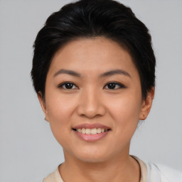 Joyful asian young-adult female with short  brown hair and brown eyes