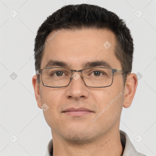 Joyful white young-adult male with short  black hair and brown eyes