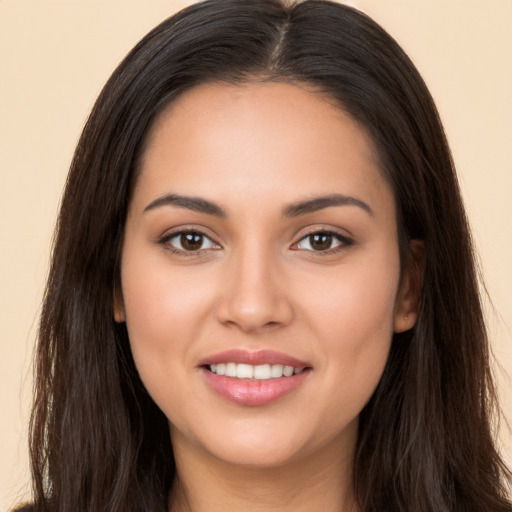 Joyful white young-adult female with long  brown hair and brown eyes