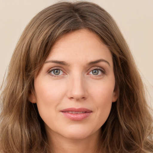 Joyful white young-adult female with long  brown hair and green eyes