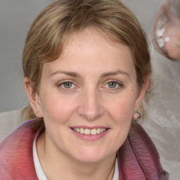 Joyful white young-adult female with medium  brown hair and blue eyes