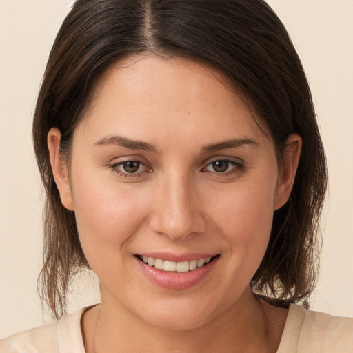 Joyful white young-adult female with medium  brown hair and brown eyes