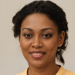 Joyful black adult female with medium  brown hair and brown eyes