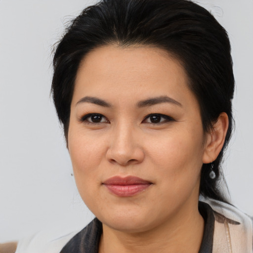 Joyful asian young-adult female with medium  brown hair and brown eyes