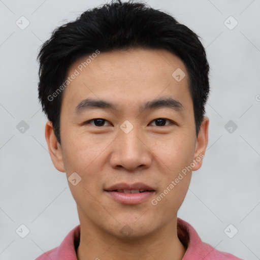 Joyful asian young-adult male with short  black hair and brown eyes