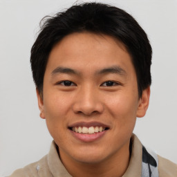 Joyful asian young-adult male with short  brown hair and brown eyes