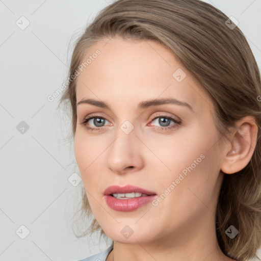 Joyful white young-adult female with medium  brown hair and blue eyes