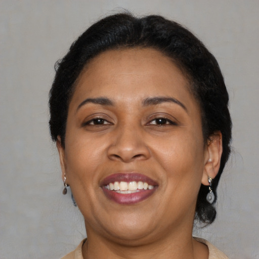 Joyful latino adult female with short  brown hair and brown eyes
