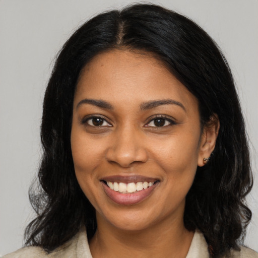 Joyful black young-adult female with medium  brown hair and brown eyes