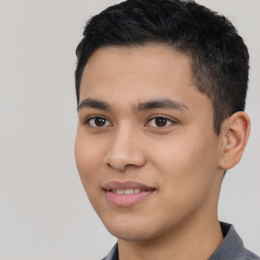 Joyful latino young-adult male with short  black hair and brown eyes