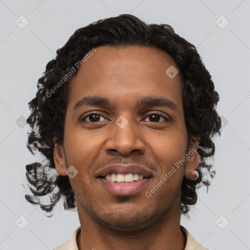 Joyful black young-adult male with short  brown hair and brown eyes