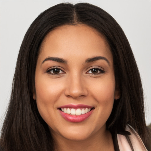 Joyful latino young-adult female with long  brown hair and brown eyes