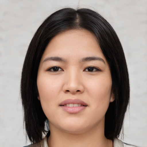Joyful asian young-adult female with medium  black hair and brown eyes