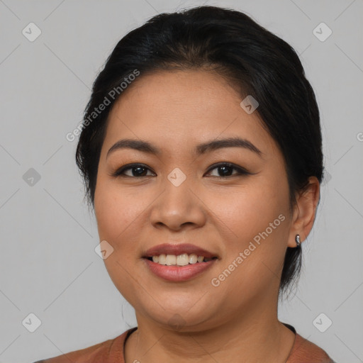 Joyful latino young-adult female with medium  brown hair and brown eyes