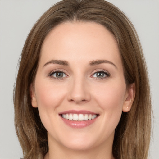 Joyful white young-adult female with long  brown hair and green eyes