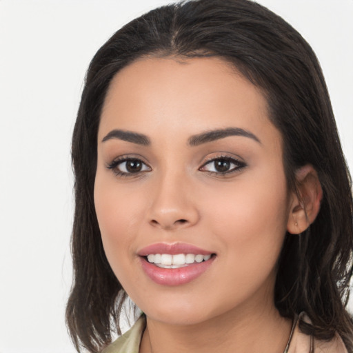 Joyful latino young-adult female with long  black hair and brown eyes