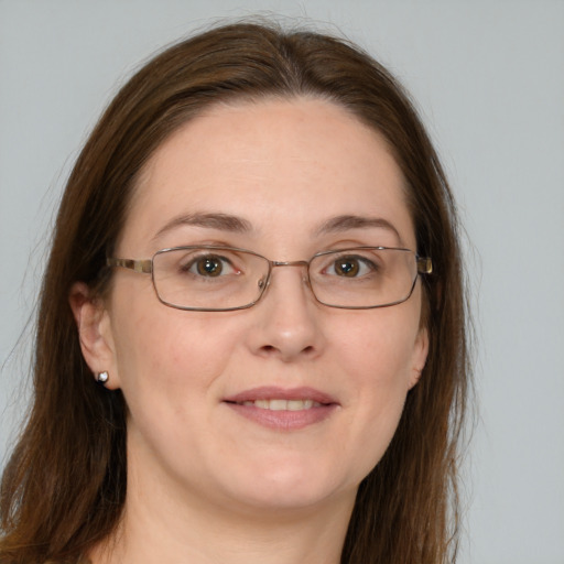 Joyful white adult female with long  brown hair and grey eyes