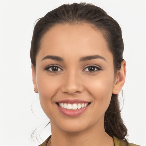 Joyful latino young-adult female with long  brown hair and brown eyes