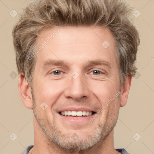 Joyful white adult male with short  brown hair and grey eyes