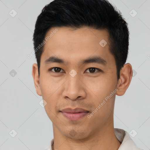 Joyful asian young-adult male with short  black hair and brown eyes