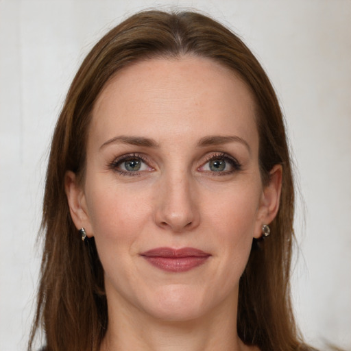 Joyful white adult female with long  brown hair and grey eyes