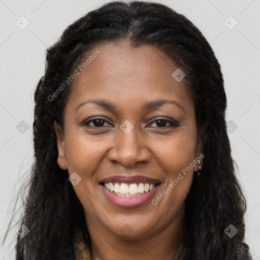 Joyful black young-adult female with long  brown hair and brown eyes