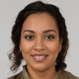 Joyful latino young-adult female with medium  brown hair and brown eyes