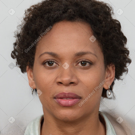 Joyful black adult female with short  brown hair and brown eyes