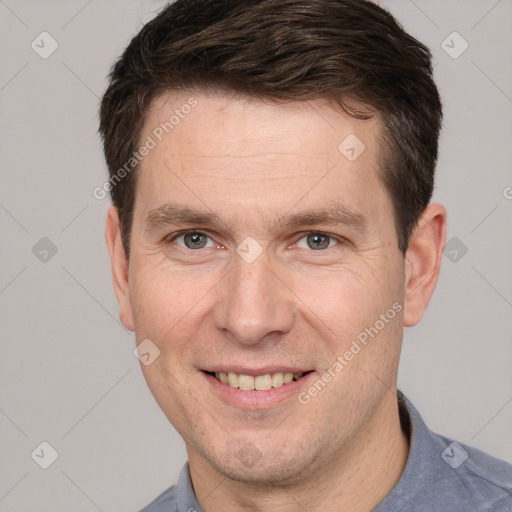 Joyful white adult male with short  brown hair and grey eyes