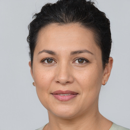 Joyful white adult female with short  brown hair and brown eyes
