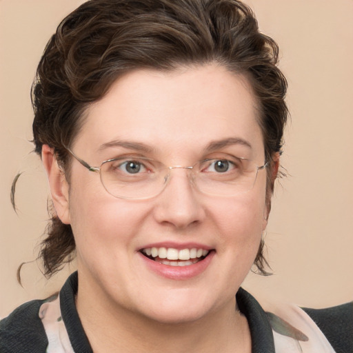 Joyful white adult female with medium  brown hair and blue eyes