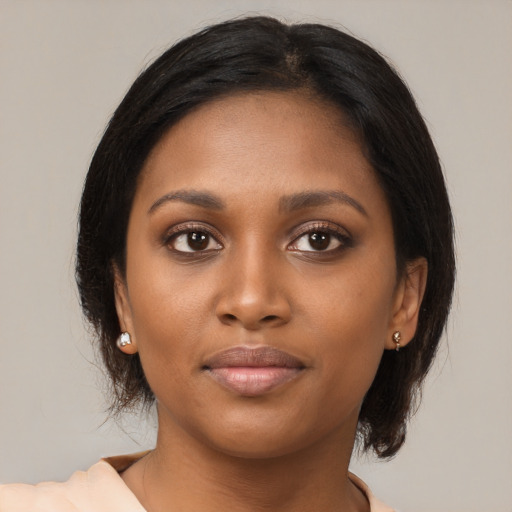 Joyful black young-adult female with medium  brown hair and brown eyes