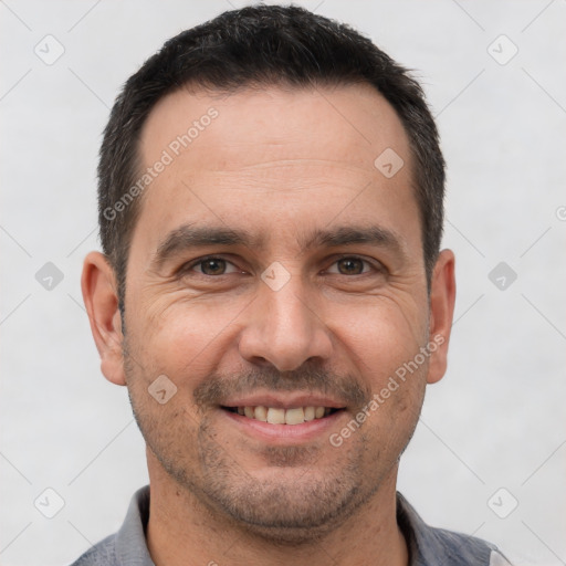 Joyful white adult male with short  brown hair and brown eyes