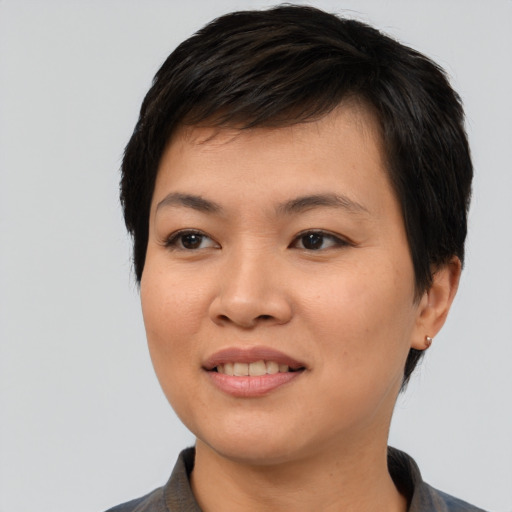 Joyful asian young-adult female with short  black hair and brown eyes