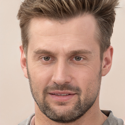 Joyful white adult male with short  brown hair and brown eyes