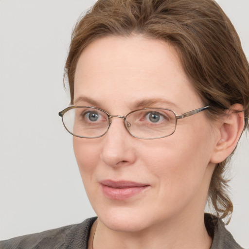 Joyful white adult female with medium  brown hair and blue eyes