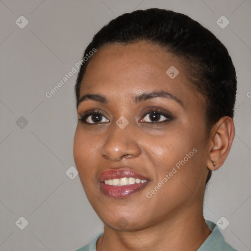 Joyful black young-adult female with short  black hair and brown eyes