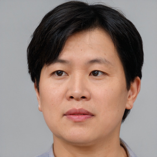 Neutral asian adult male with short  brown hair and brown eyes