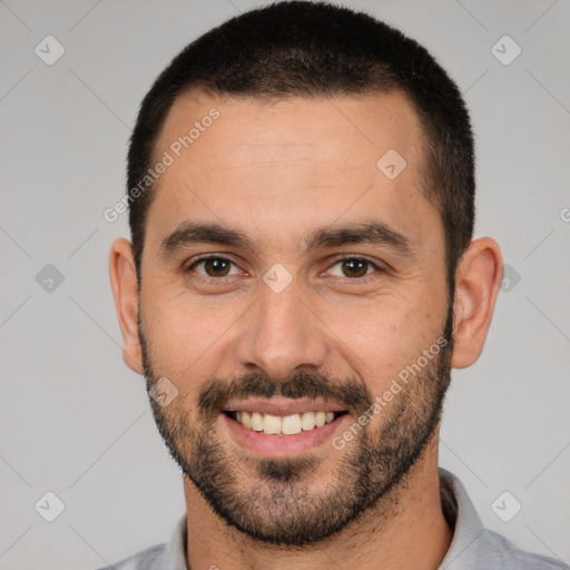 Joyful white young-adult male with short  black hair and brown eyes