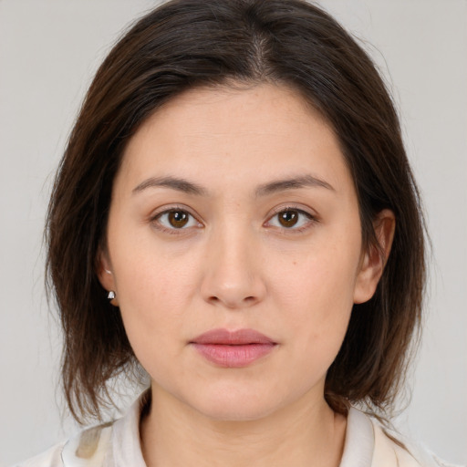 Joyful white young-adult female with medium  brown hair and brown eyes