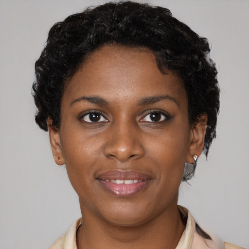 Joyful black young-adult female with short  brown hair and brown eyes