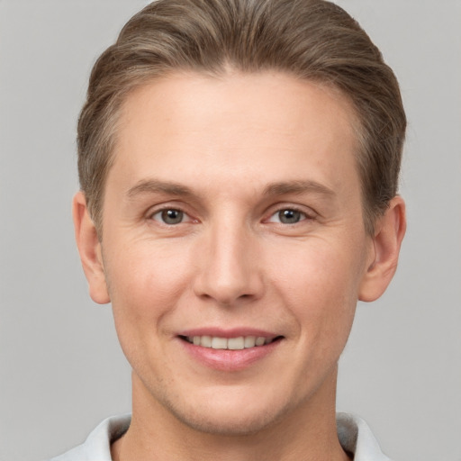 Joyful white adult male with short  brown hair and grey eyes