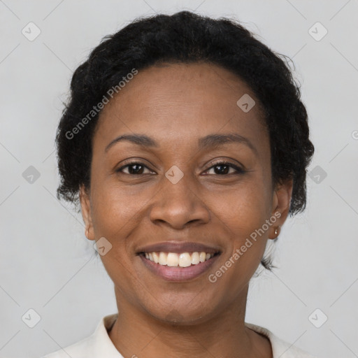 Joyful black adult female with short  brown hair and brown eyes