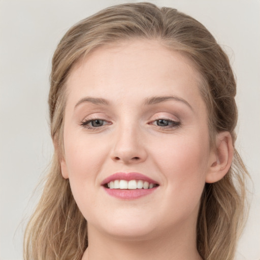 Joyful white young-adult female with long  brown hair and grey eyes