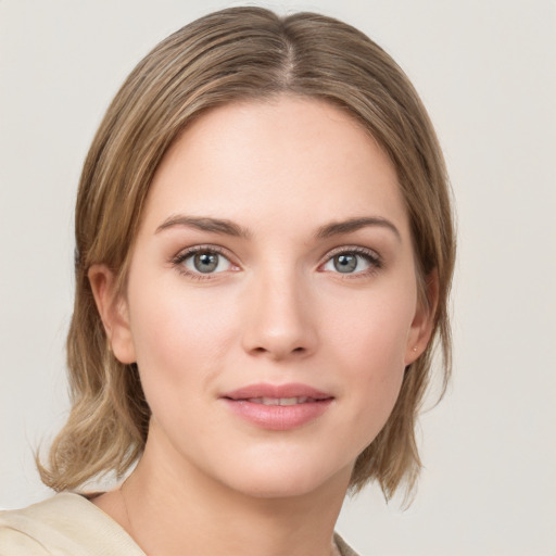 Joyful white young-adult female with medium  brown hair and green eyes