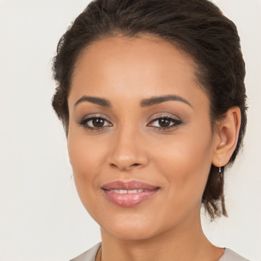 Joyful latino young-adult female with medium  brown hair and brown eyes