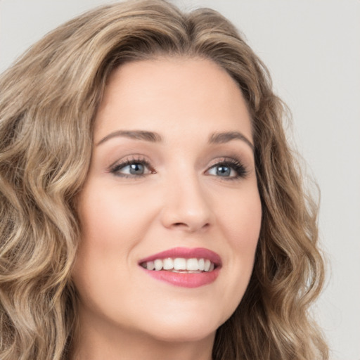 Joyful white young-adult female with long  brown hair and green eyes