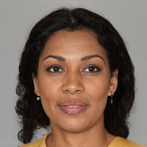Joyful black young-adult female with medium  brown hair and brown eyes
