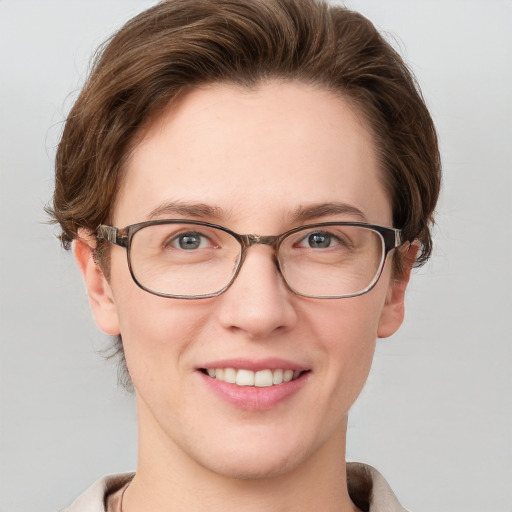 Joyful white young-adult female with short  brown hair and grey eyes