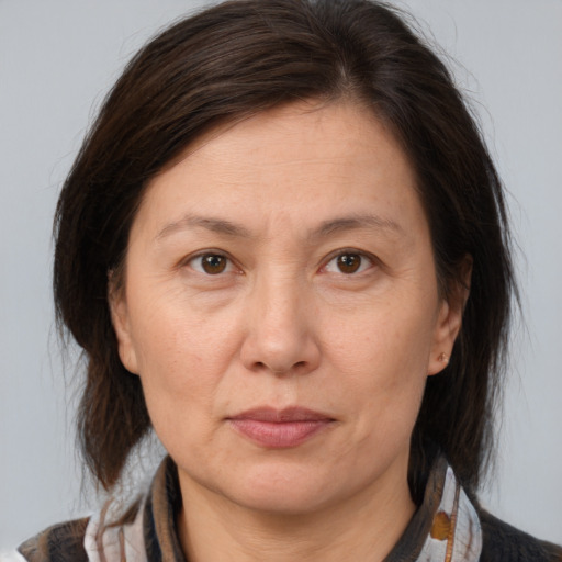 Joyful white adult female with medium  brown hair and brown eyes